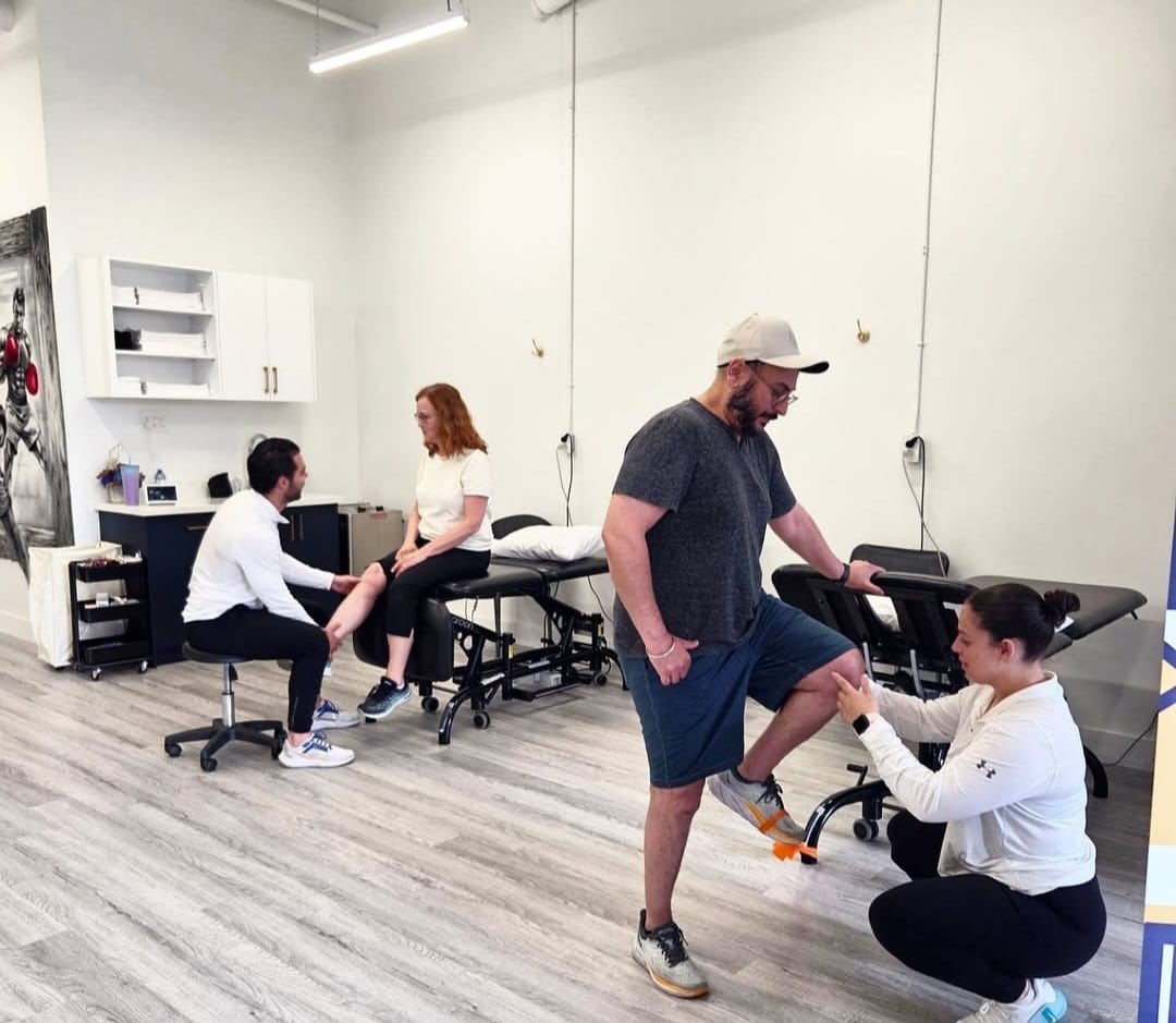 Two men playing football after a physio session